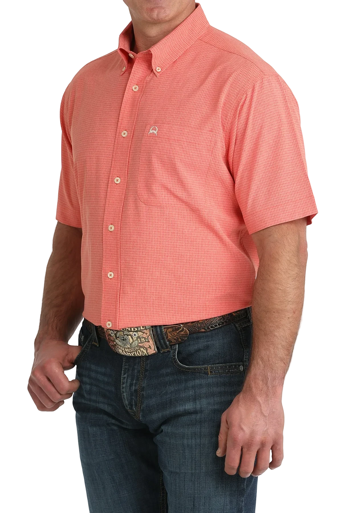 Man wearing a coral patterned short-sleeve shirt and blue jeans on a white background
