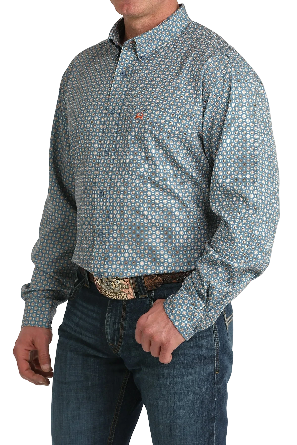 Man wearing a patterned long-sleeve shirt and jeans on a white background