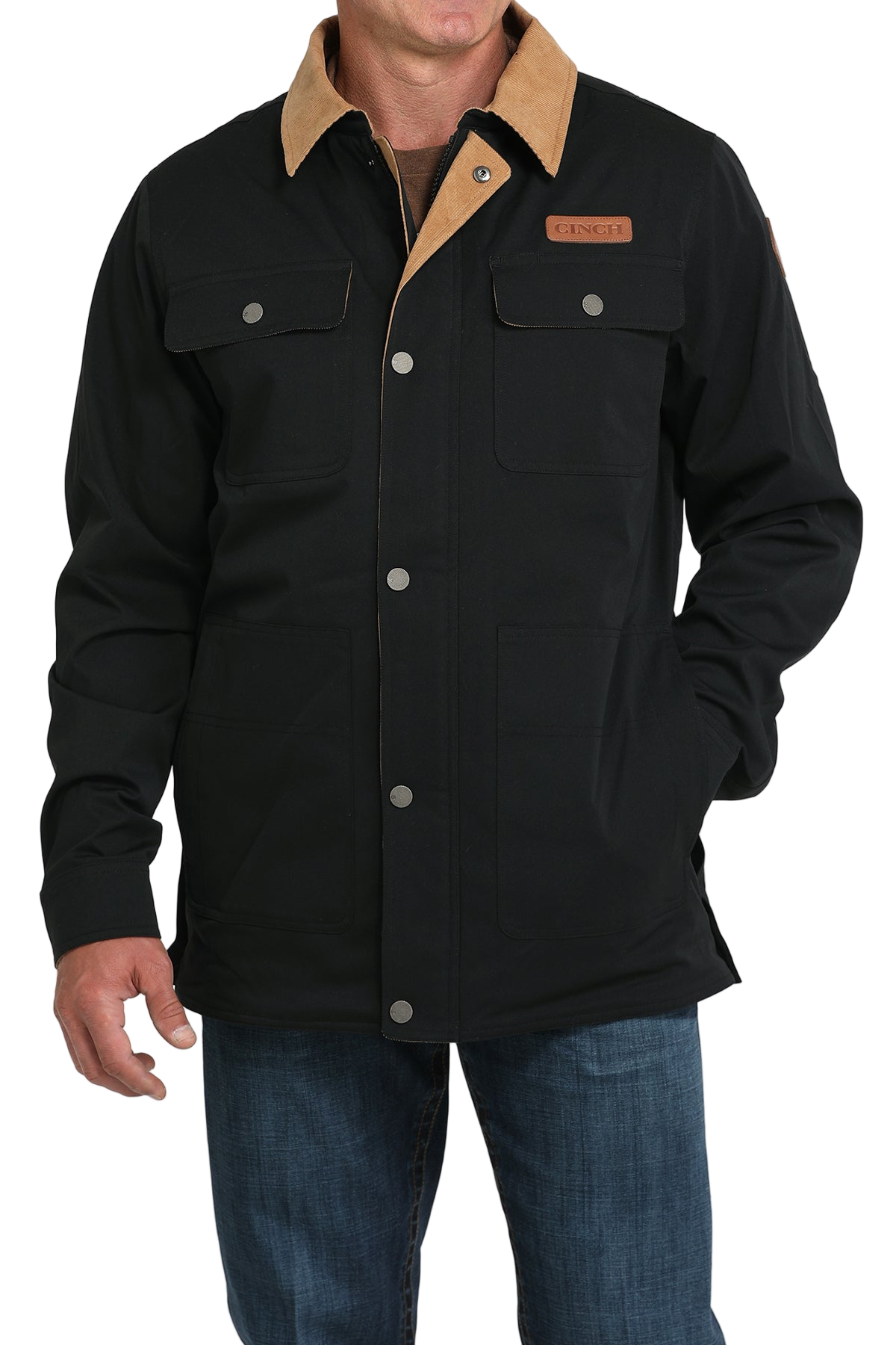 Man wearing a black jacket with a tan corduroy collar and blue jeans