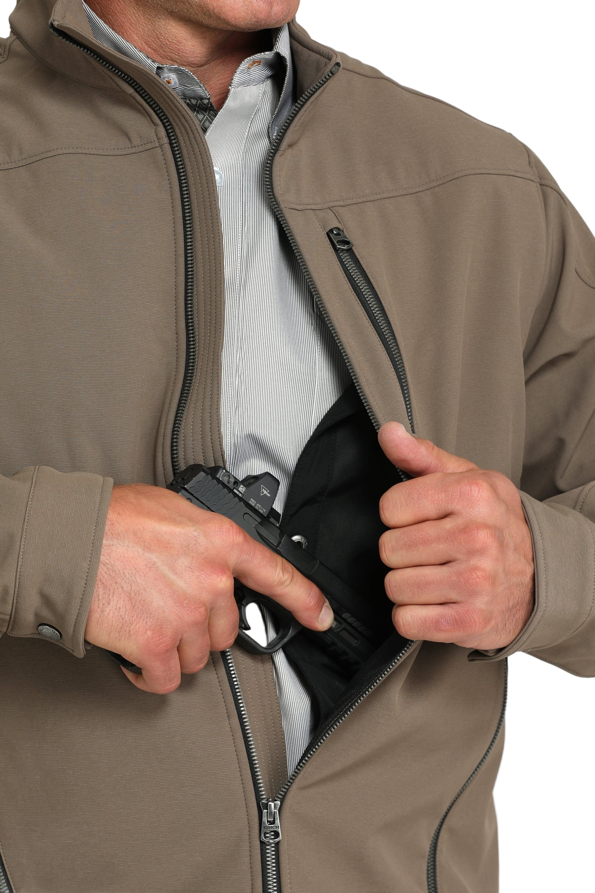 Man wearing a brown jacket, shown partially unzipped to reveal an interior concealed-carry pocket
