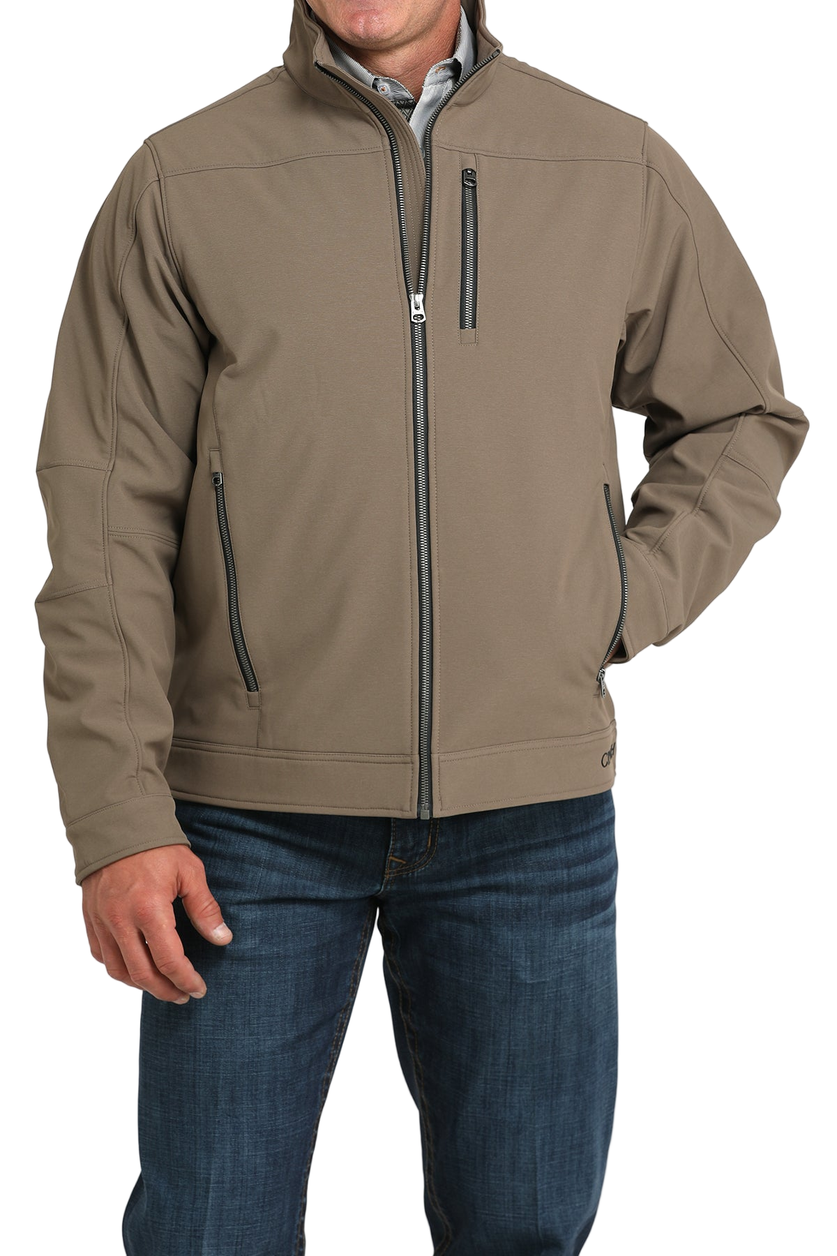 Man wearing a tan zip-front jacket, paired with dark jeans