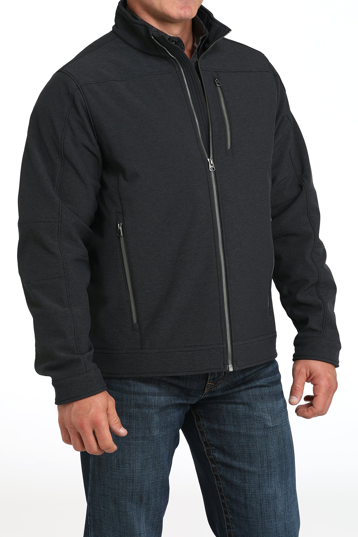 Man wearing a black jacket and jeans on a white background