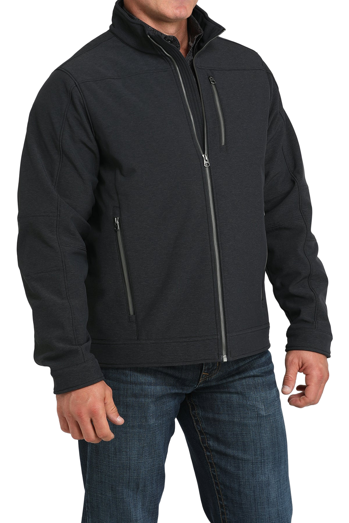 Man wearing a black zip-front jacket, paired with dark jeans