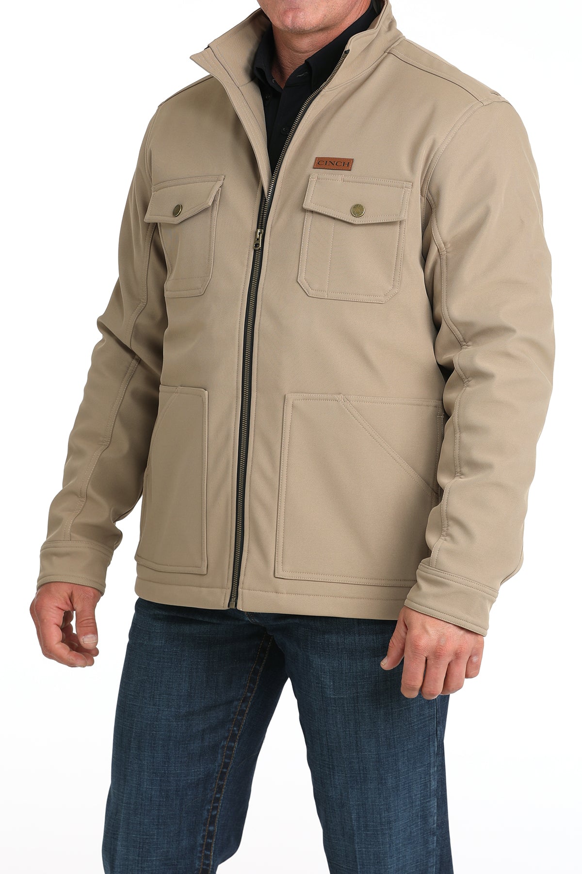 Man wearing a khaki jacket and jeans on a white background
