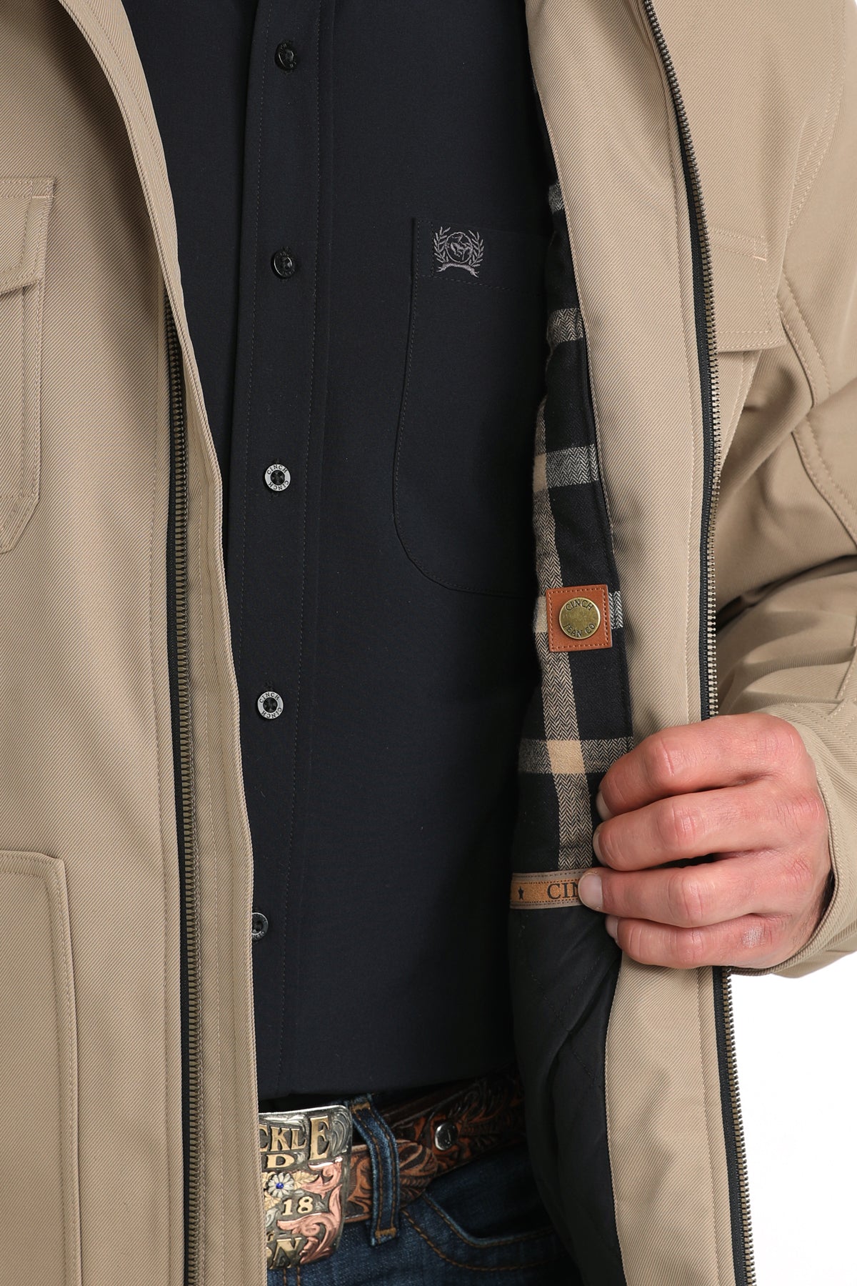 Man wearing a khaki jacket showing the patterned interior 