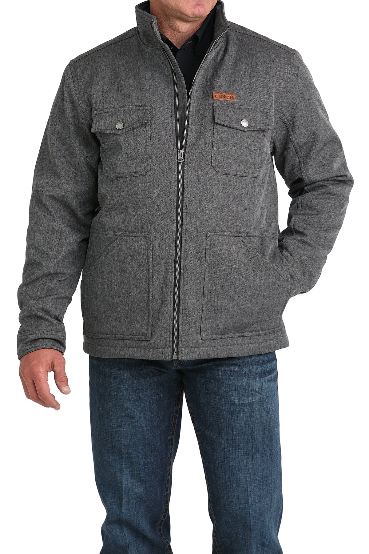 Man wearing a gray zip-front jacket, paired with dark jeans