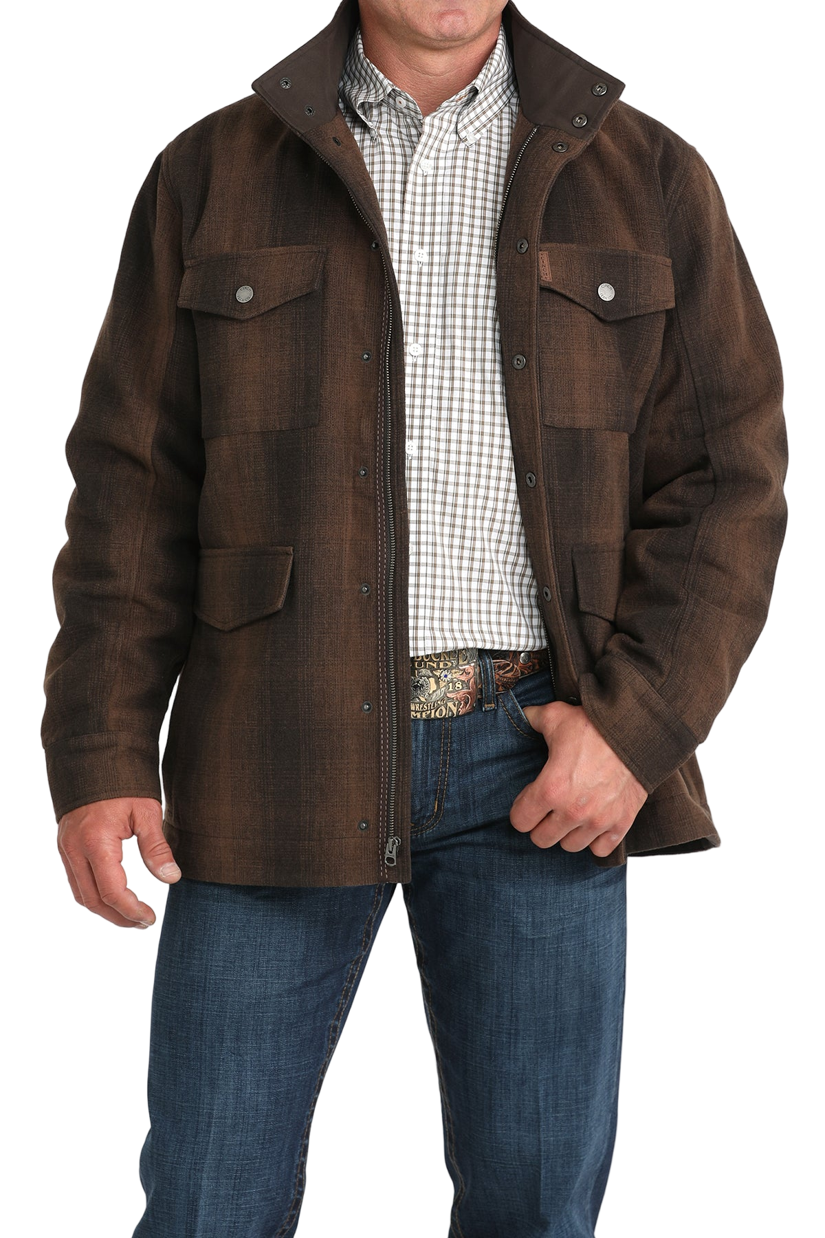 Man wearing a brown button-front jacket with multiple flap pockets, a patterned undershirt, and blue jeans