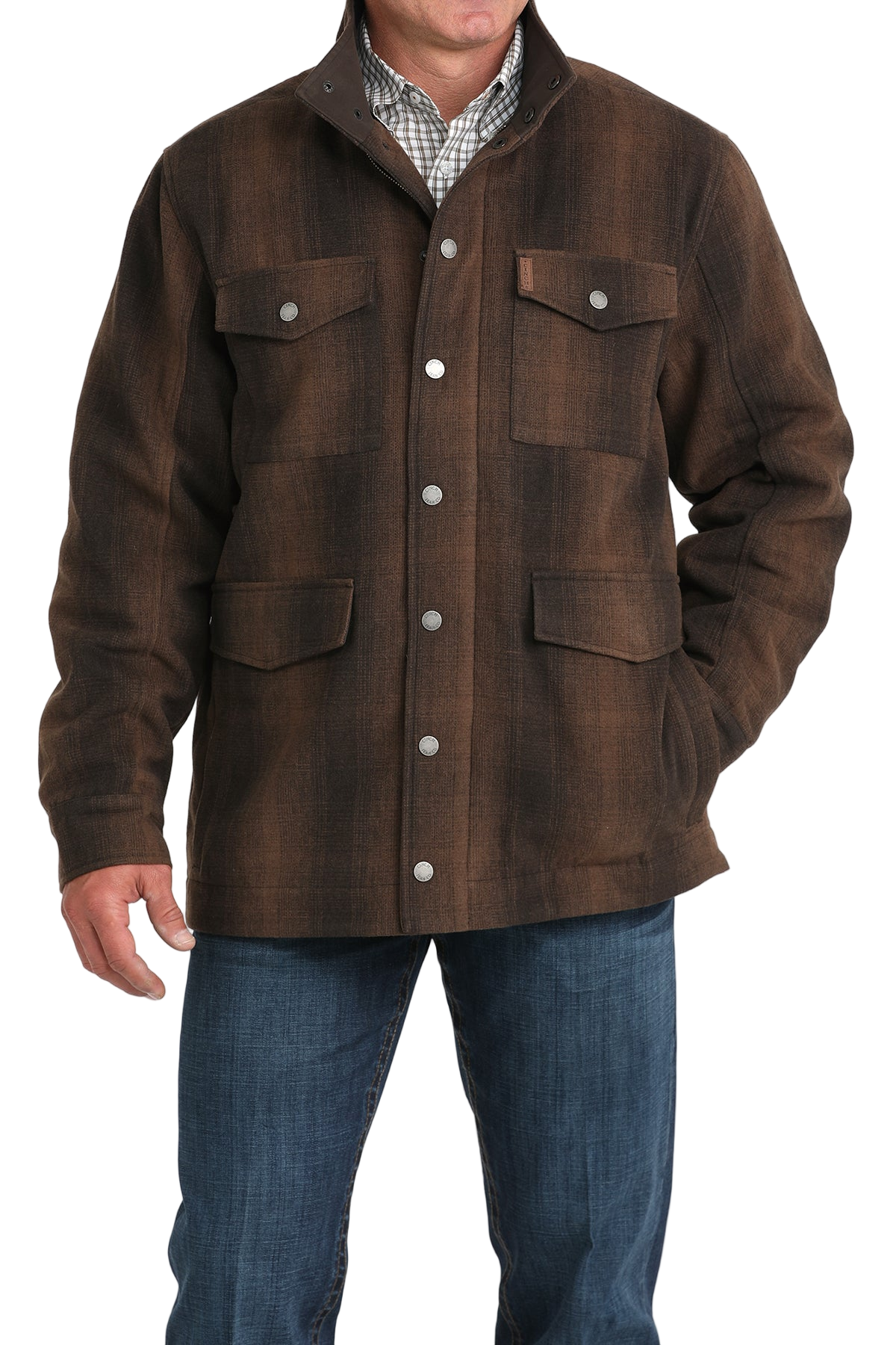 Man wearing a brown button-front jacket with multiple flap pockets, paired with blue jeans