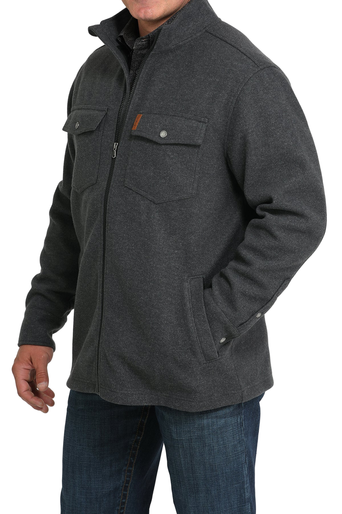 Man wearing a dark gray zip-front jacket with flap chest pockets, paired with blue jeans