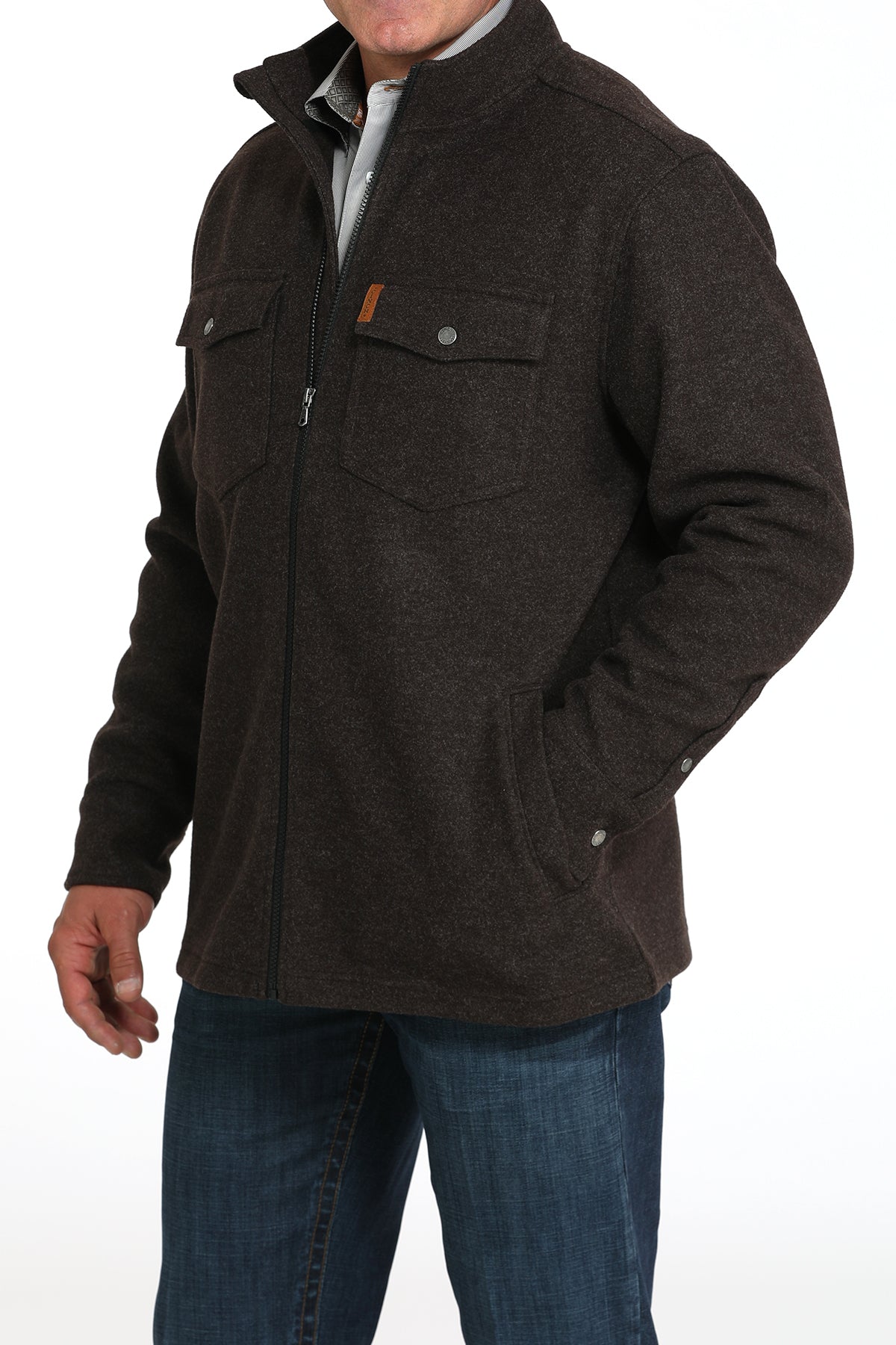 Man wearing a brown jacket and jeans 