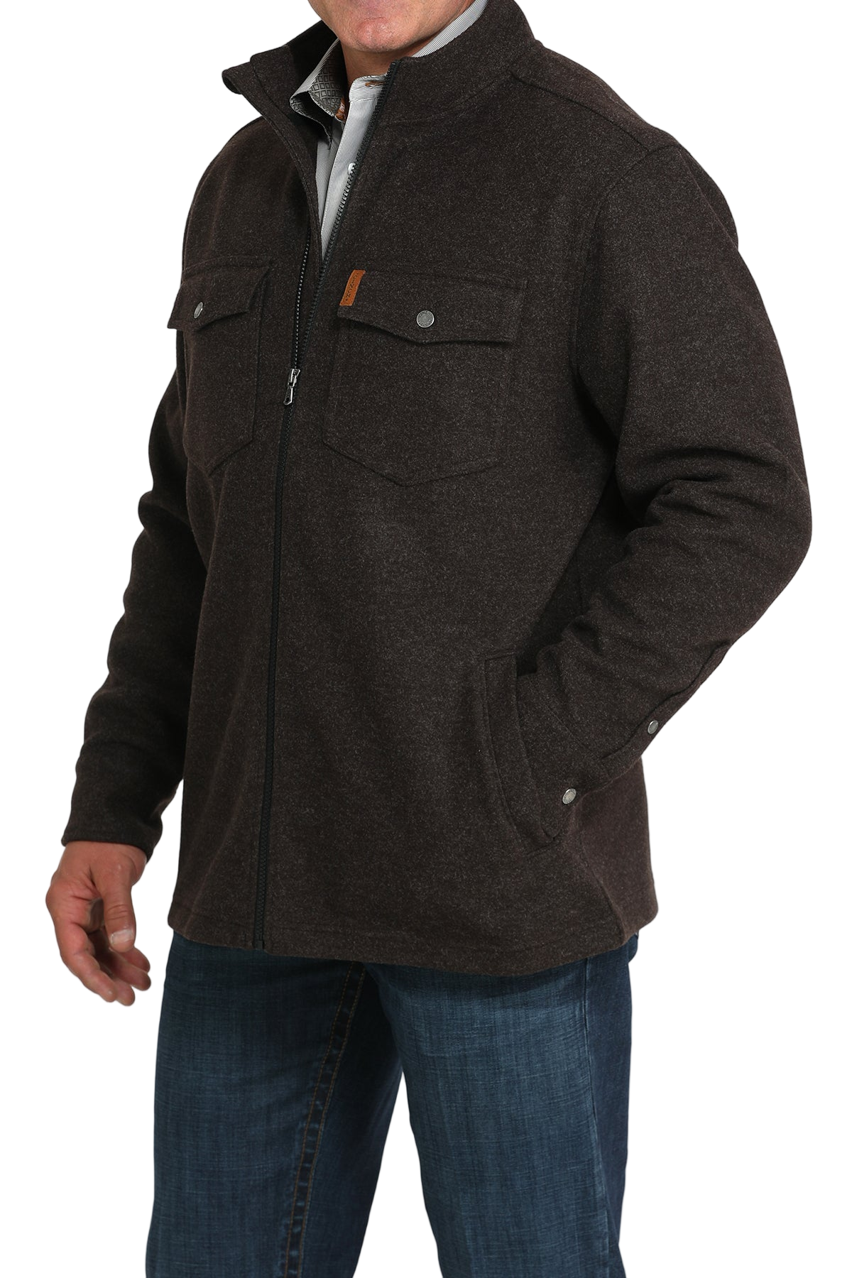 Man wearing a dark brown zip-front jacket with flap chest pockets, paired with blue jeans