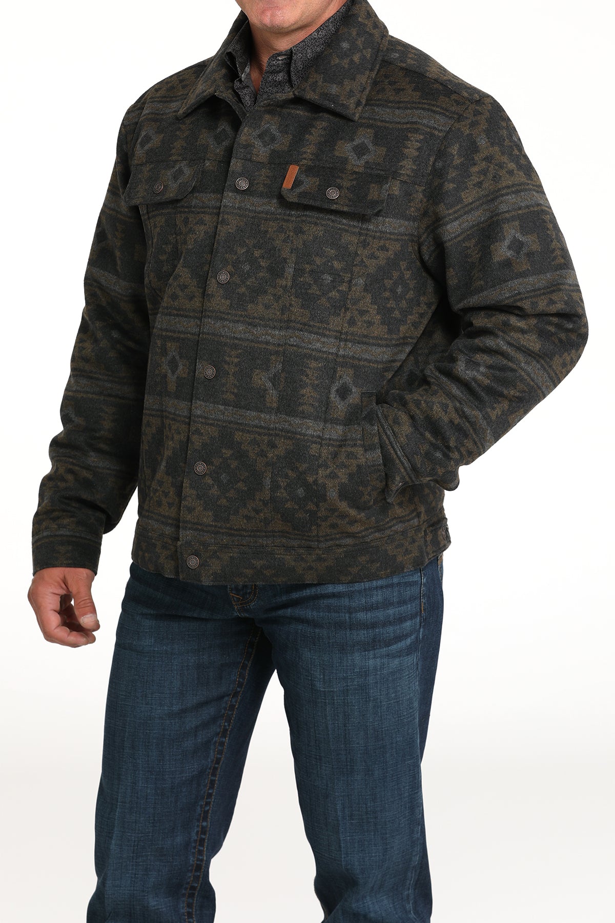 Man wearing a gray patterned jacket with jeans 