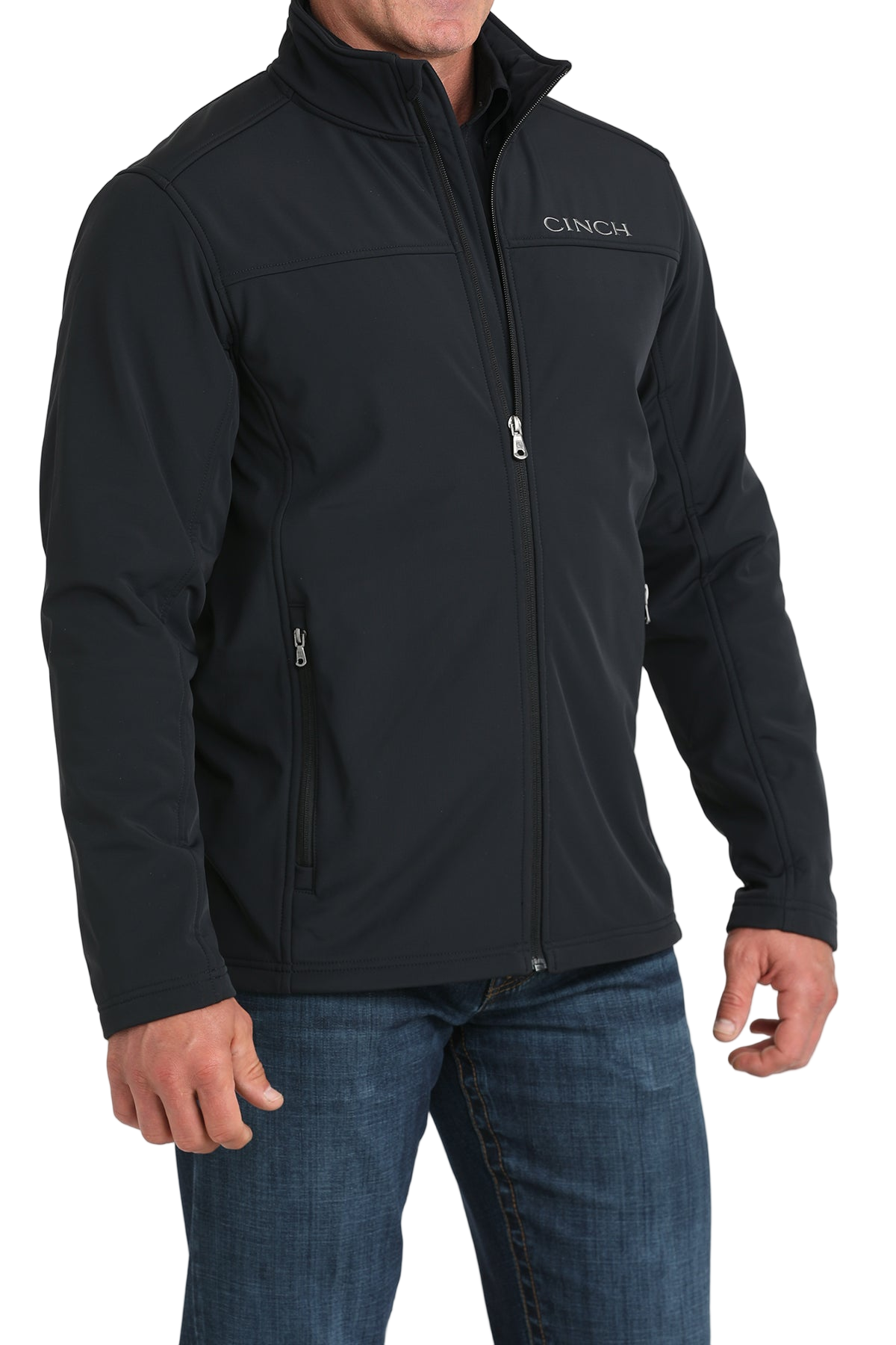Man wearing a black CINCH jacket with a front zipper, paired with blue jeans