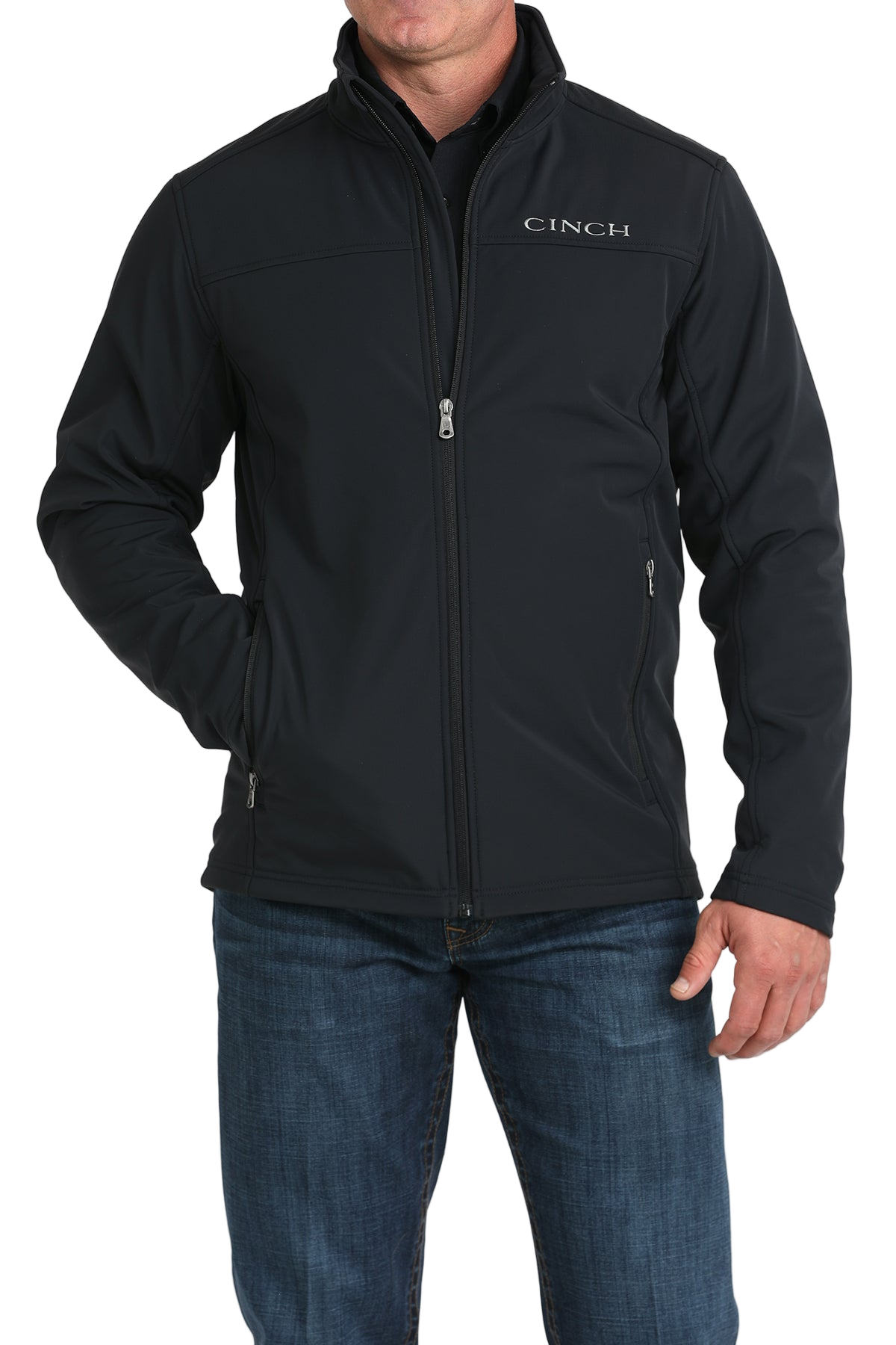 Man wearing a black CINCH jacket with a front zipper, paired with blue jeans