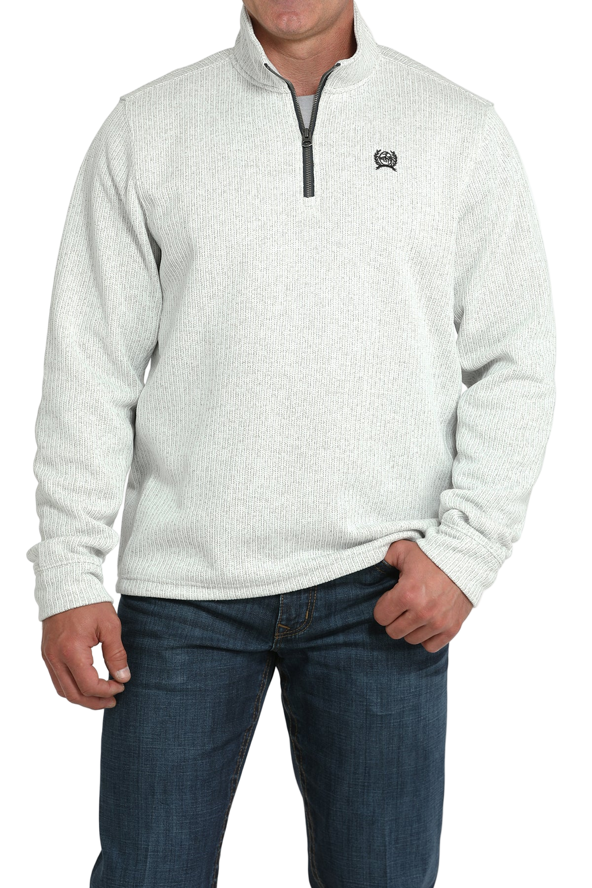 Man wearing a light gray textured quarter-zip pullover with dark jeans