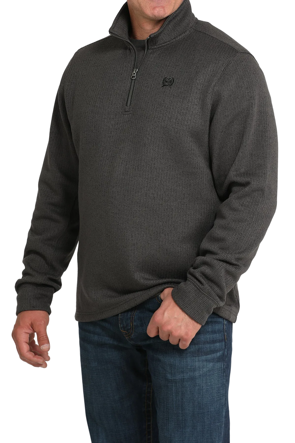 Man wearing a dark gray pullover with a logo on a white background