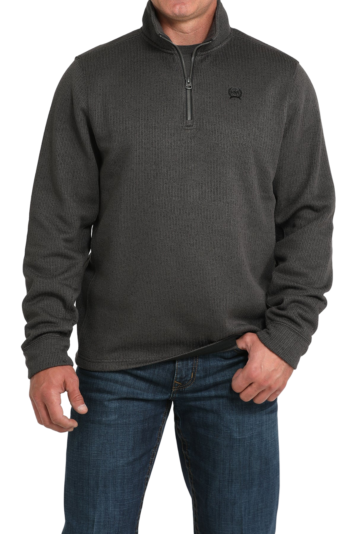 Man wearing a gray quarter-zip sweater and blue jeans on a white background