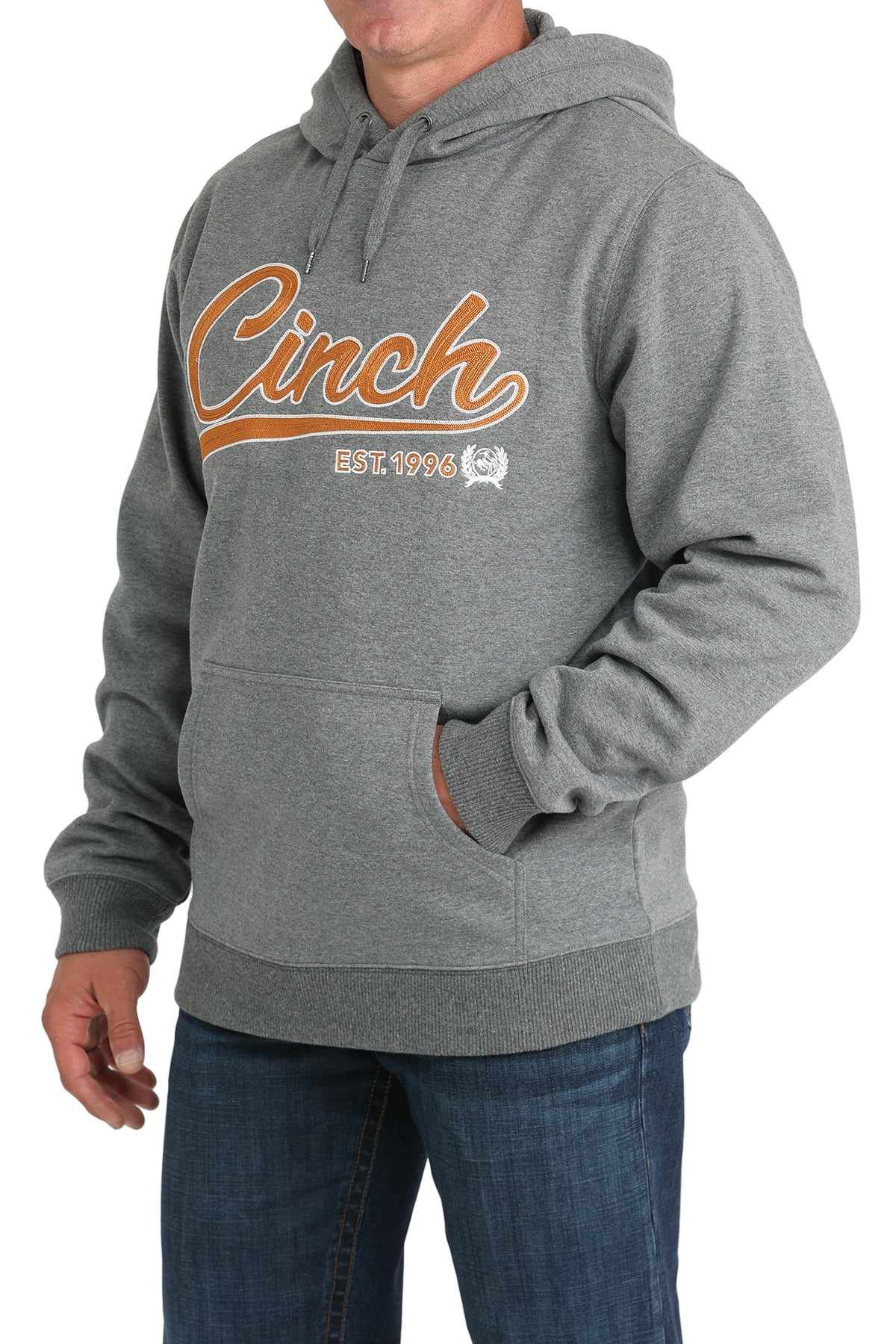 Man wearing a gray hoodie with a 'Cinch' logo written in orange lettering across the front, paired with jeans on a transparent background