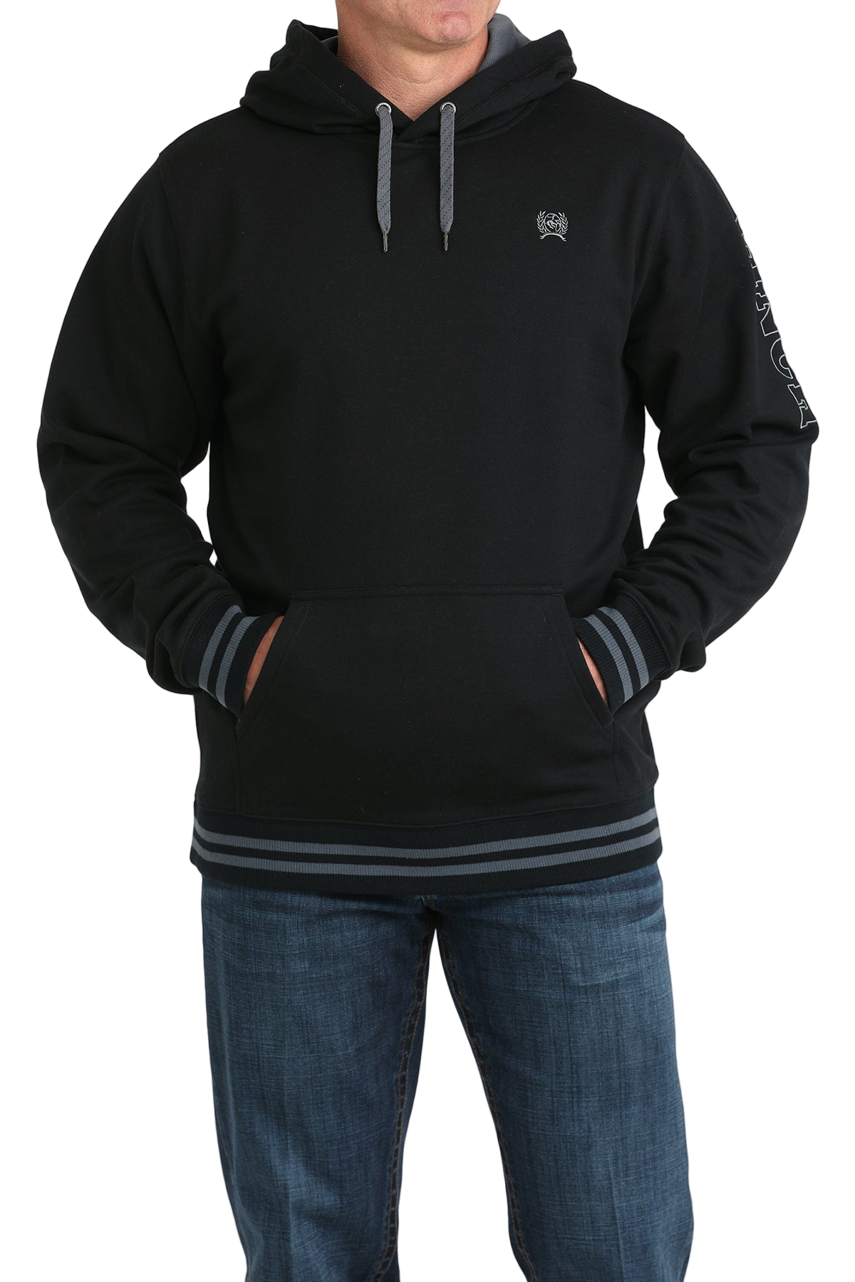 Man wearing a black hoodie with a small 'Cinch' logo on the chest, and 'Cinch' logo down the arm, paired with jeans on a transparent background