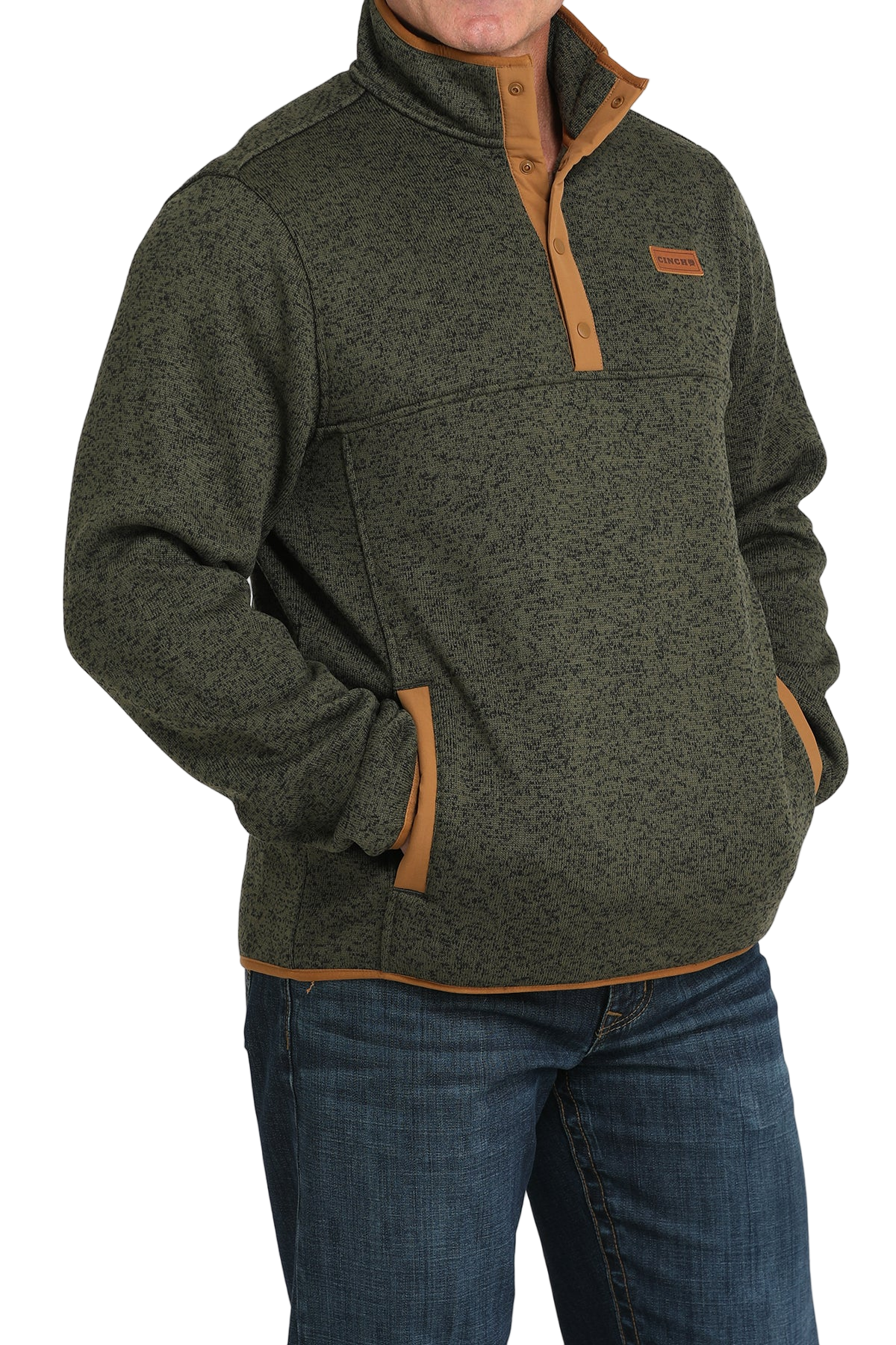 Man wearing a green textured pullover with a snap-button placket, stand-up collar, and front hand pockets, paired with blue jeans