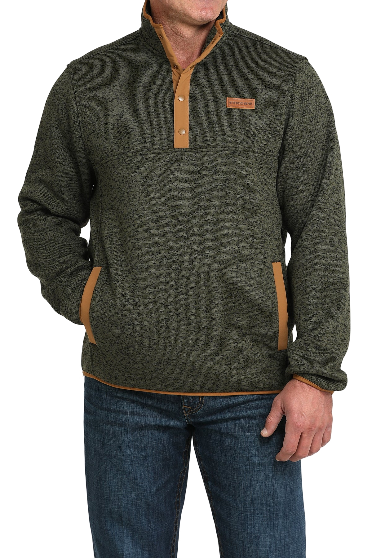 Man wearing a green textured pullover with a snap-button placket, stand-up collar, and front hand pockets, paired with blue jeans