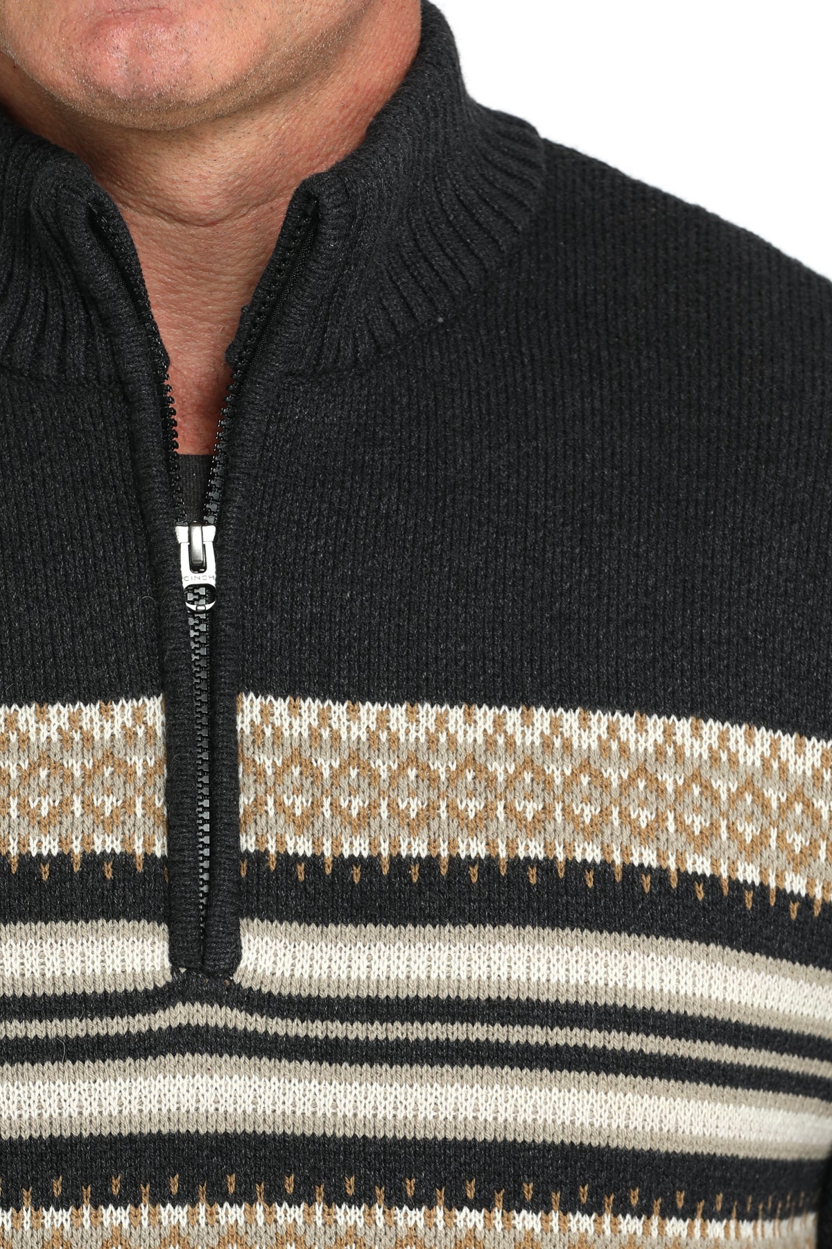 Close-up of a man wearing a 1/4 zip sweater with stripes