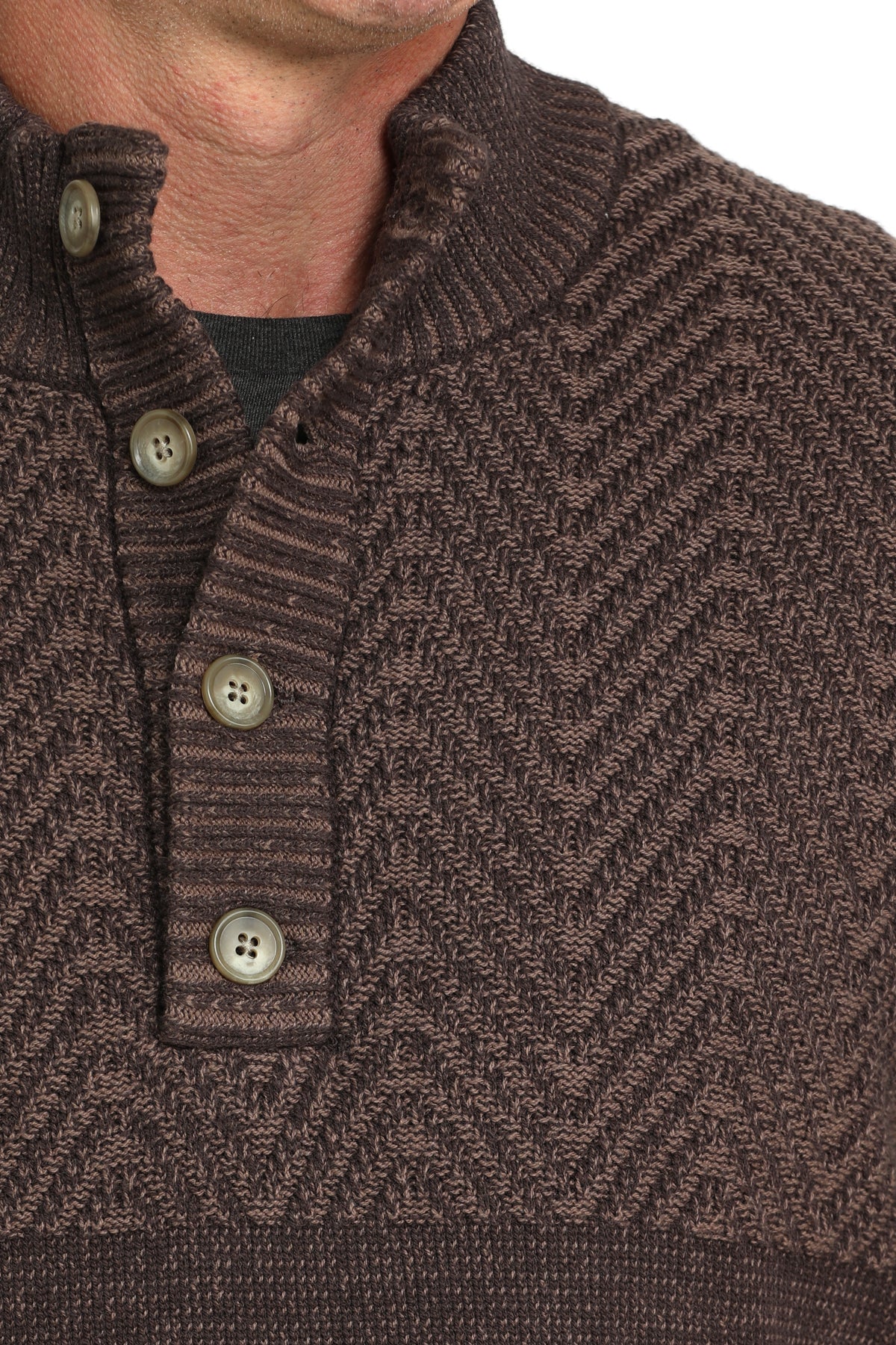 Close-up of a man wearing a brown pullover sweater with buttons