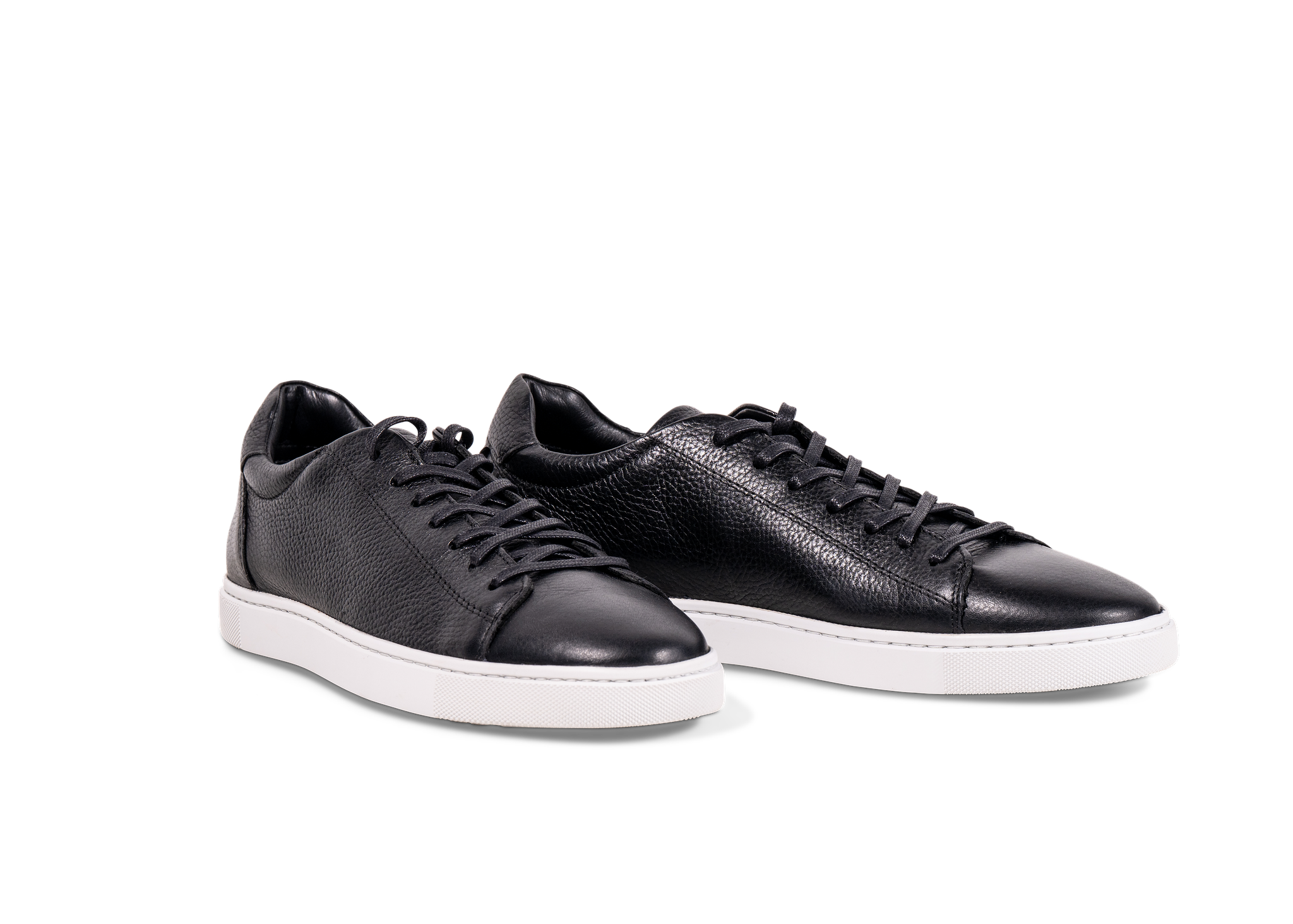 Pair of Go West Supply black leather sneakers with a white sole on a white background