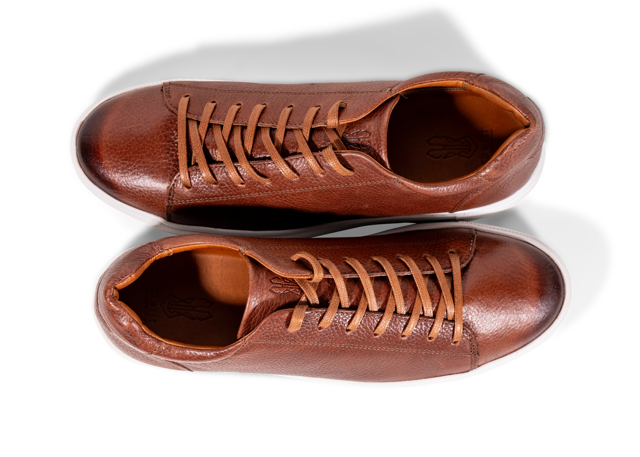 Pair of Go West Supply brown leather sneakers on a white background