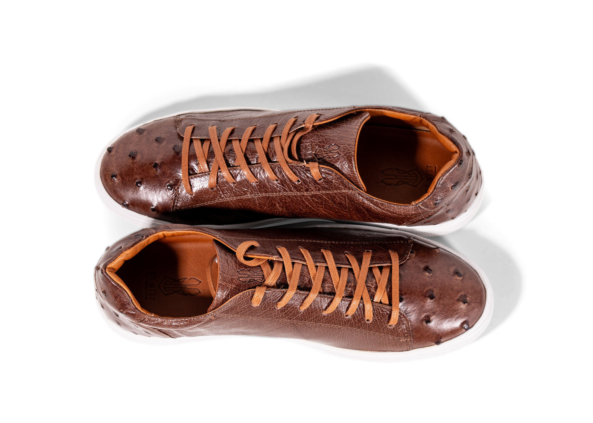 Pair of Go West Supply cognac ostrich leather shoes on a white background