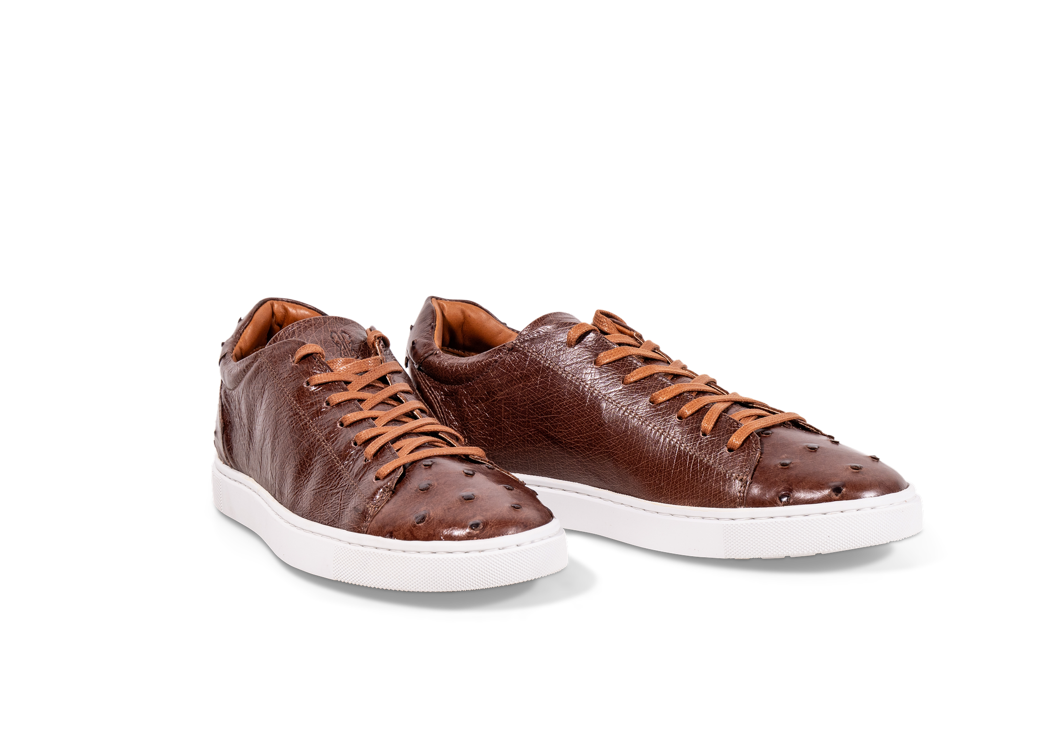 Pair of Go West Supply cognac ostrich leather sneakers on a white background
