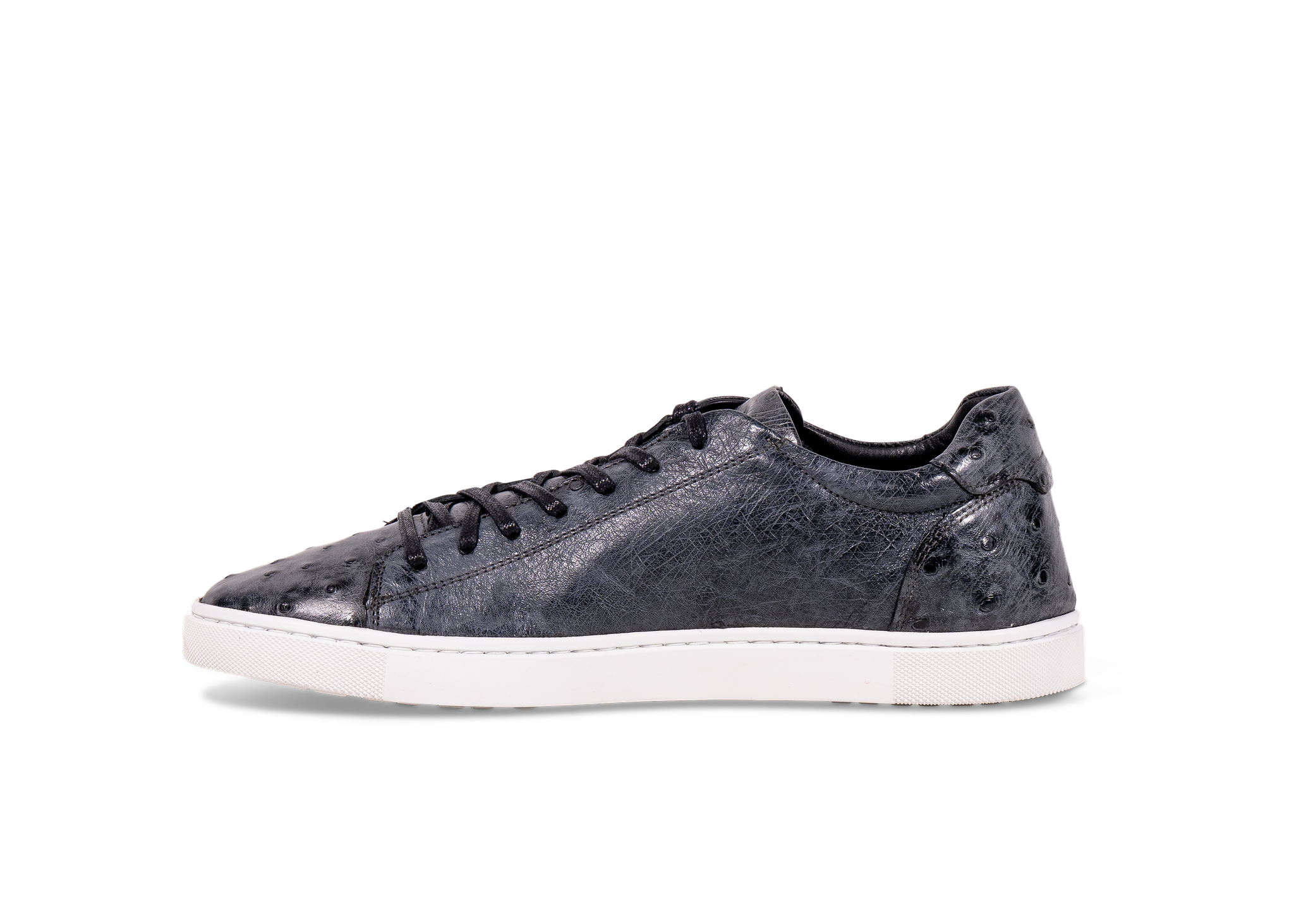 Pair of Go West Supply navy ostrich leather sneakers with a white sole on a white background