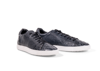 Pair of Go West Supply navy ostrich leather sneakers on a white background