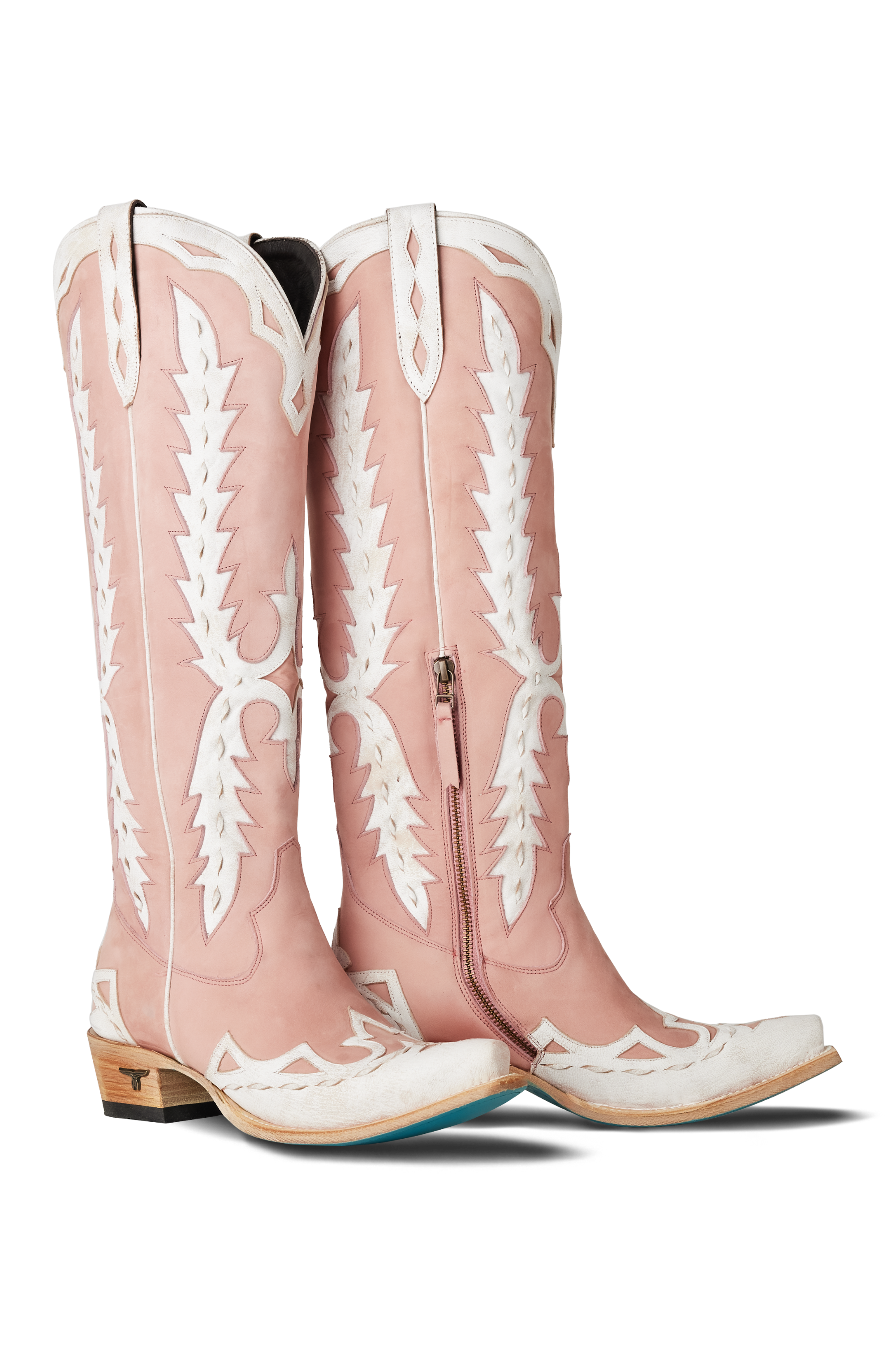 Pink cowboy boots with white patterns on a white background