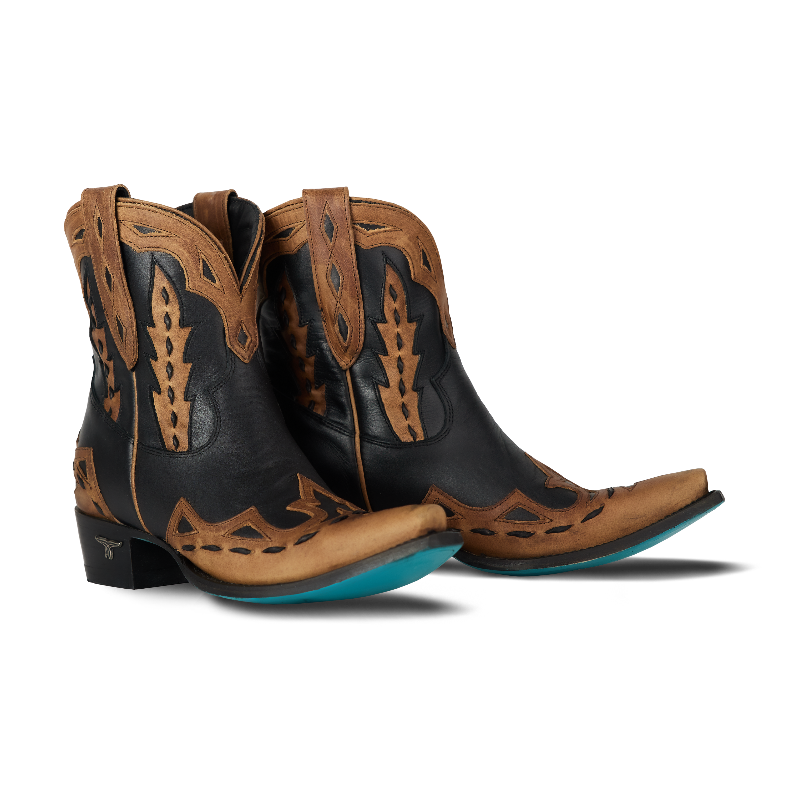 Pair of black and brown cowboy boots with turquoise soles on a white background