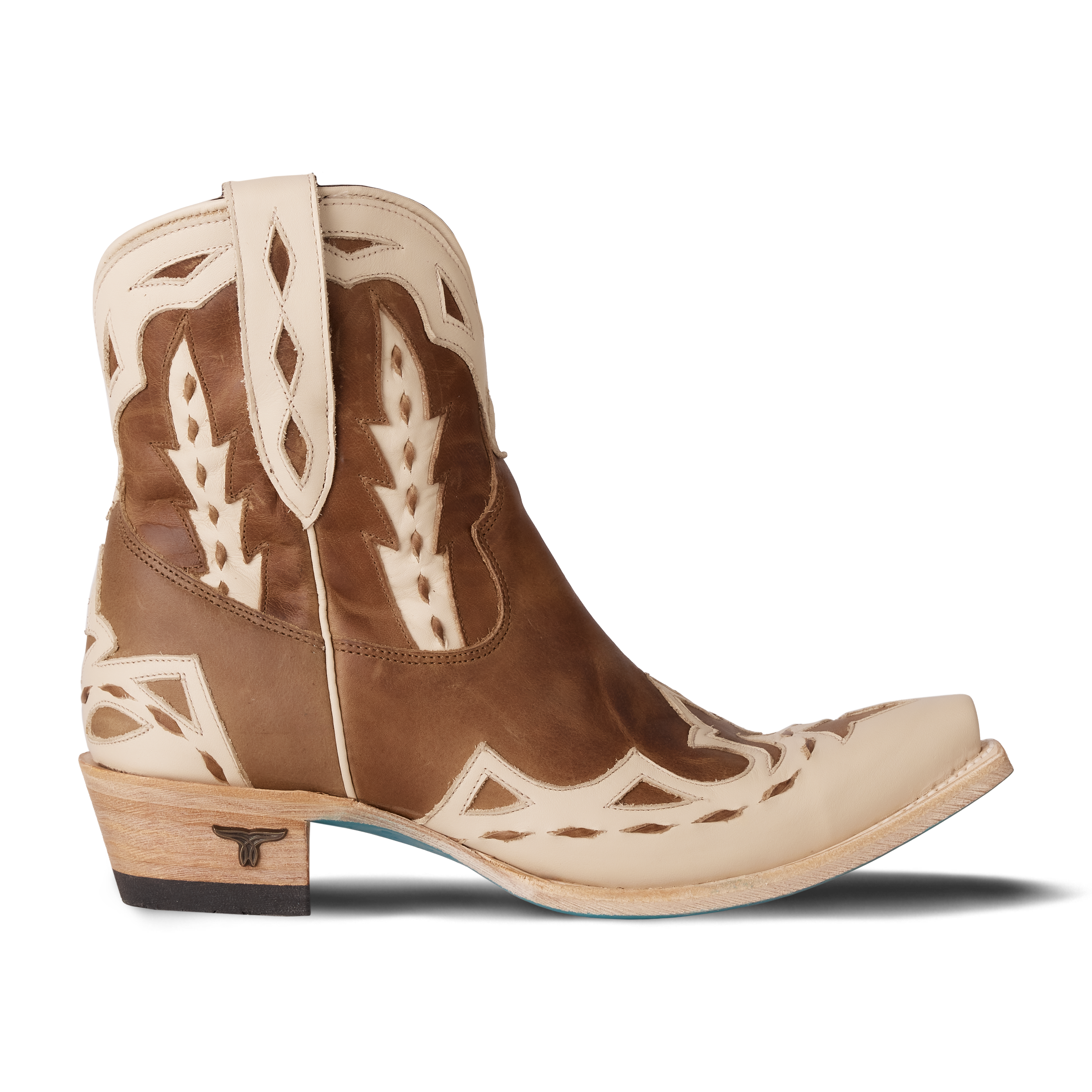 A brown and cream western ankle boot featuring detailed stitching, a short shaft with pull tabs, and contrasting cream overlays 