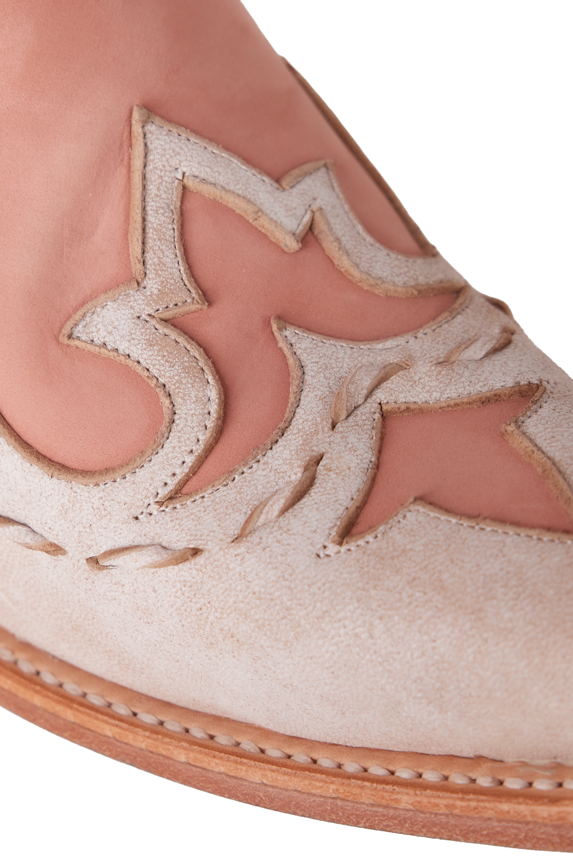 Close-up of a sandal with decorative cut-out design on a white background