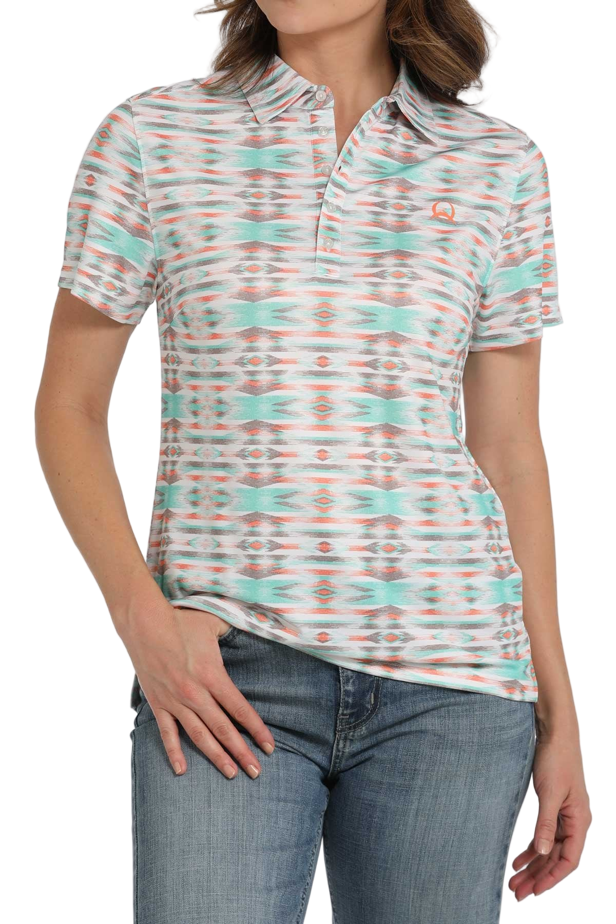 Woman wearing a patterned short-sleeve polo shirt paired with light-wash jeans