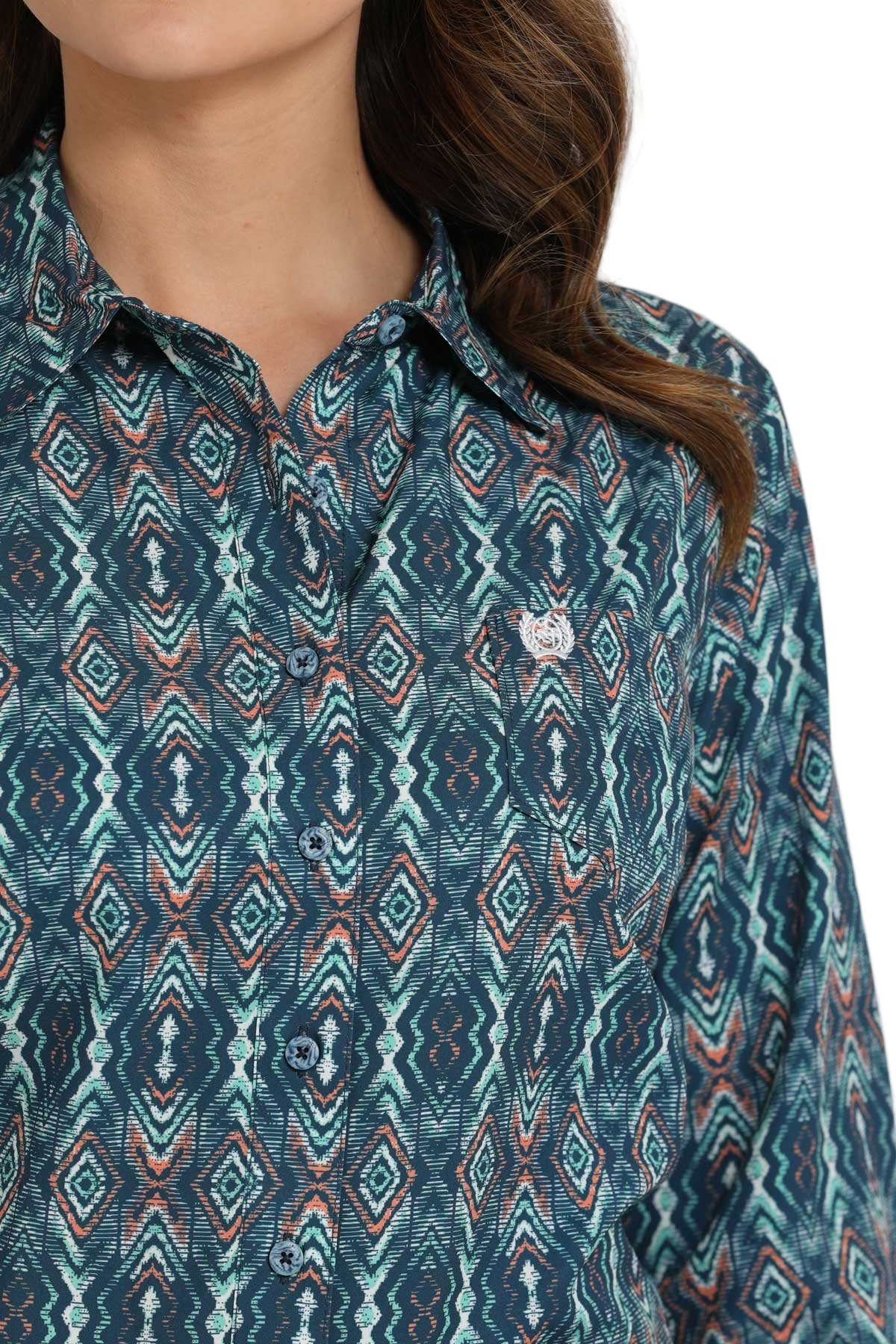 Woman wearing a teal patterned long-sleeve shirt 