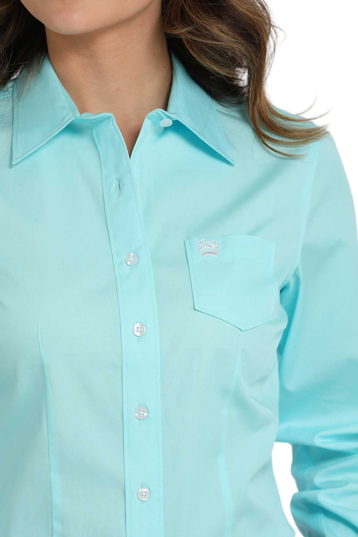 Close-up of a woman wearing a blue long-sleeve button-down shirt