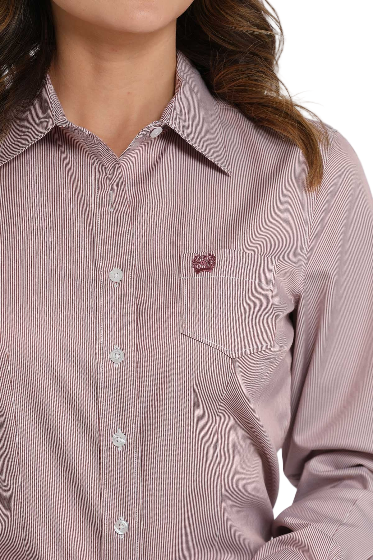 Close-up of a woman wearing a pink striped long-sleeve button-down shirt