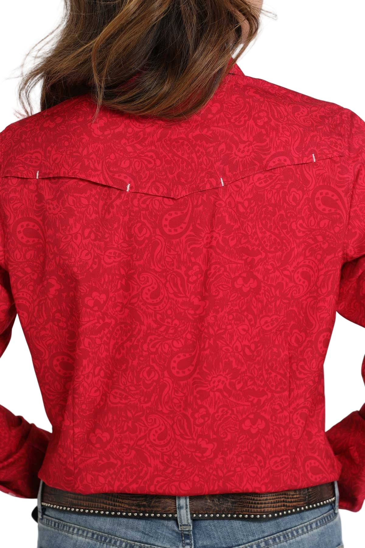 Back view of a woman wearing a red long-sleeve button-down shirt with an allover pattern