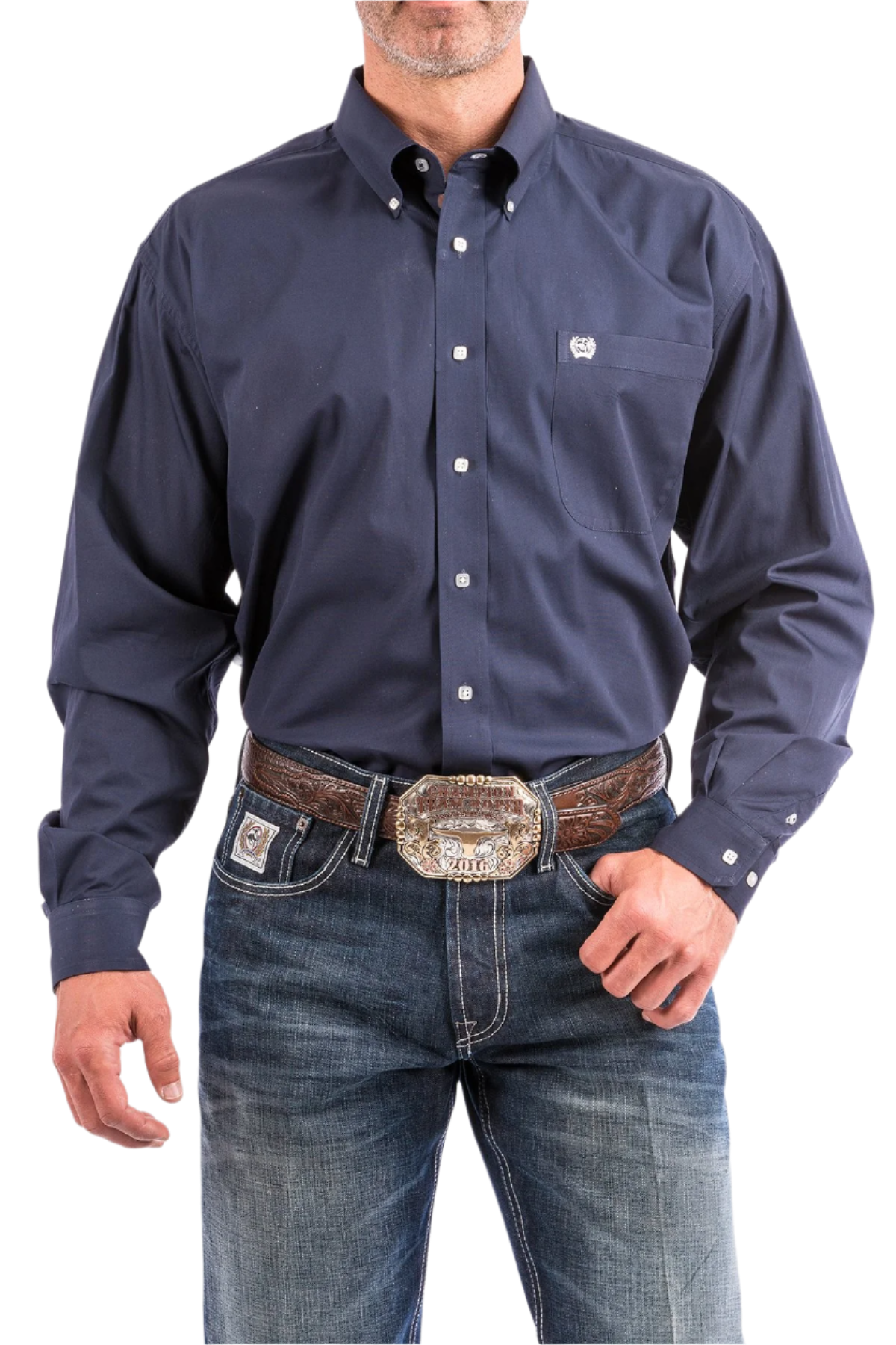 A man wearing a navy long sleeve button-down shirt and blue jeans, with a belt and buckle visible.