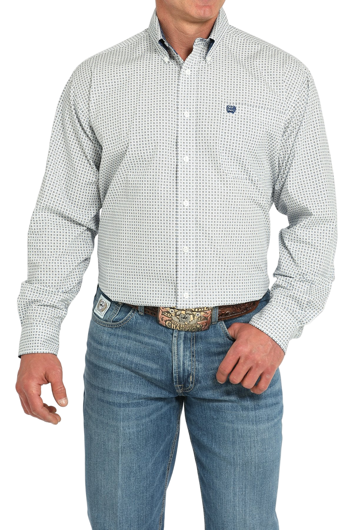 Man wearing a light gray patterned button-up shirt with blue jeans on a white background