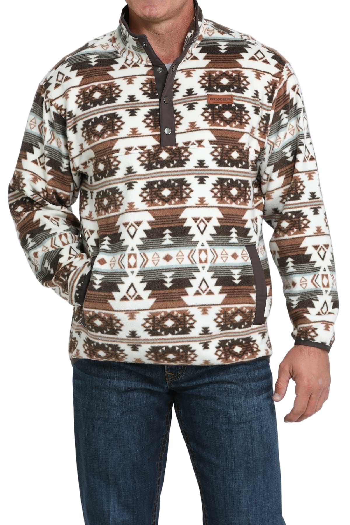 Man wearing a brown and white Aztec-pattern pullover with a snap-up collar, paired with blue jeans